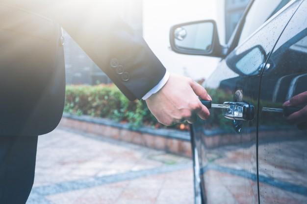 man_in_a_suit_unlocking_his_car